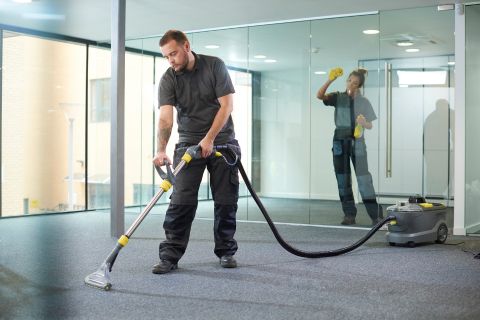 Technician performing extreme deep cleaning services in a heavily neglected residential space using HEPA-certified equipment
