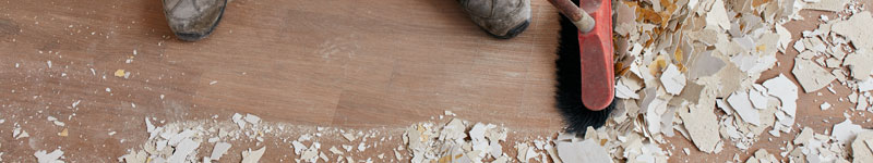 Construction debris and dust being swept during rough post construction cleaning