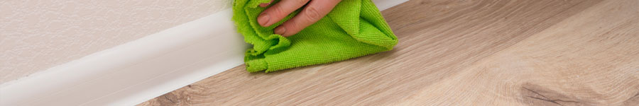 Wiping baseboards and flooring during detailed post construction cleaning